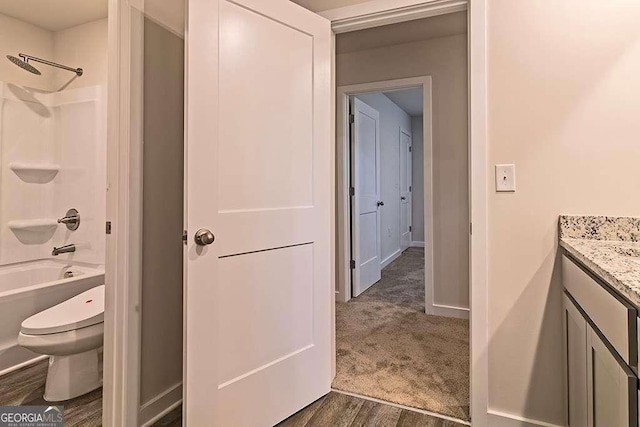 full bathroom with vanity, wood-type flooring, toilet, and shower / bath combination