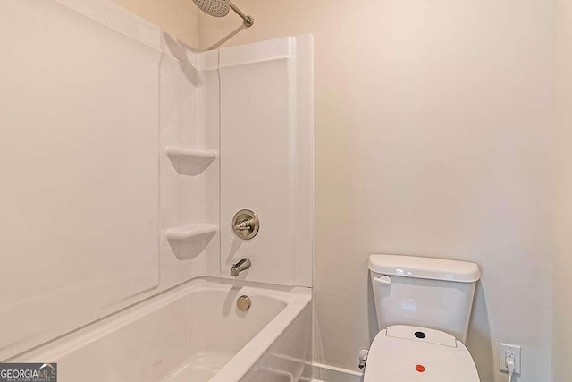 bathroom featuring shower / tub combination and toilet