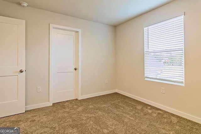 carpeted empty room with plenty of natural light