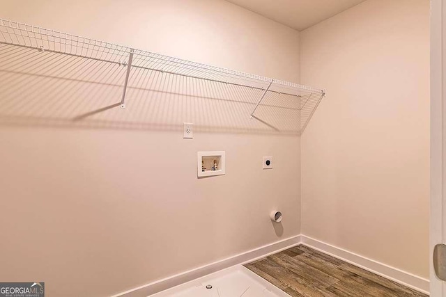 washroom featuring hookup for a washing machine, hookup for an electric dryer, and hardwood / wood-style flooring