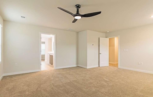 unfurnished bedroom with ensuite bath and light carpet