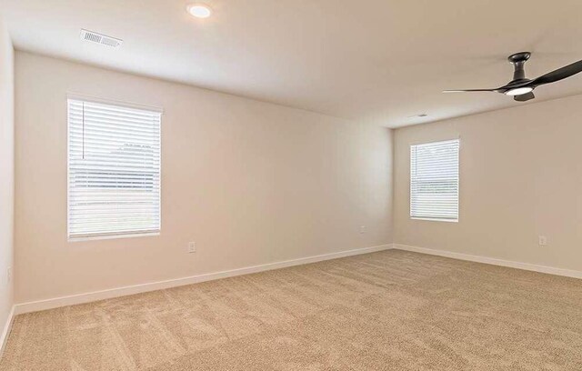 carpeted empty room with ceiling fan