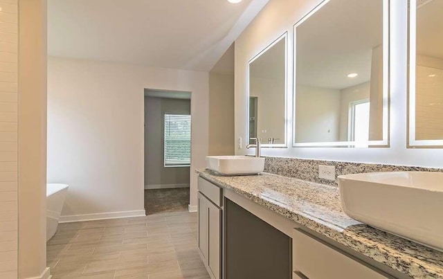 bathroom with vanity and a bath