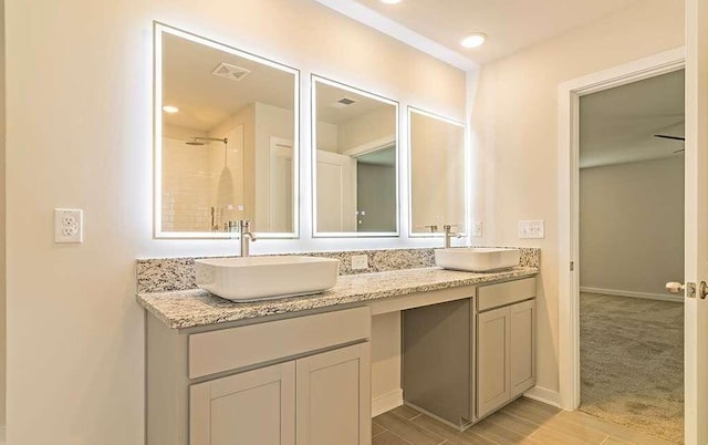 bathroom featuring vanity and a shower