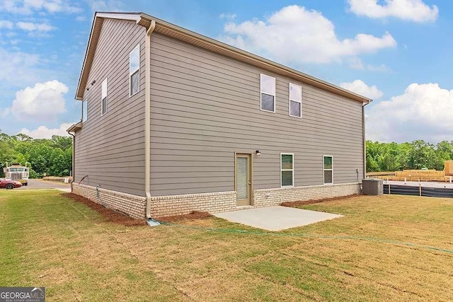 back of house featuring a yard, a patio area, and central AC