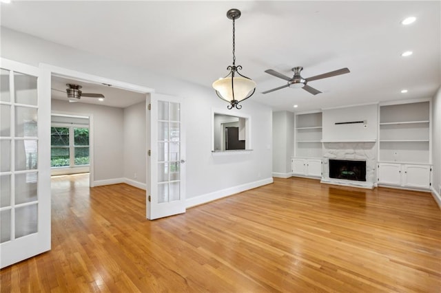 1719 Woodcliff Ct NE, Atlanta, GA 30329 - unfurnished living room featuring ceiling fan, light wood-style floors, baseboards, a fireplace with raised hearth, and recessed lighting