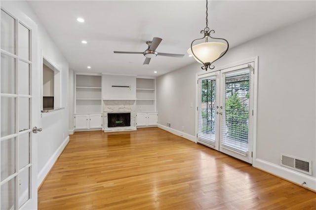 1719 Woodcliff Ct NE, Atlanta, GA 30329 - unfurnished living room with french doors, light wood-type flooring, a high end fireplace, recessed lighting, and baseboards