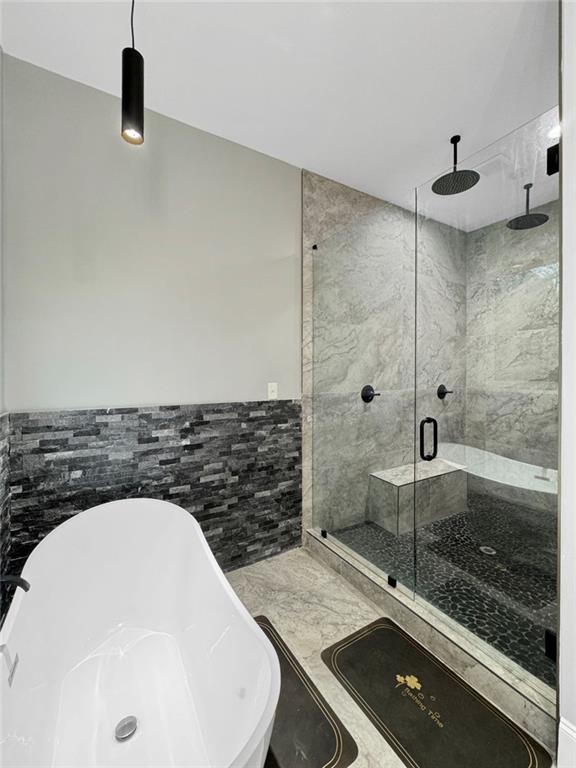 244 Coastline Rd, Fayetteville, GA 30214 - full bath with a shower stall, a freestanding tub, tile walls, and a wainscoted wall