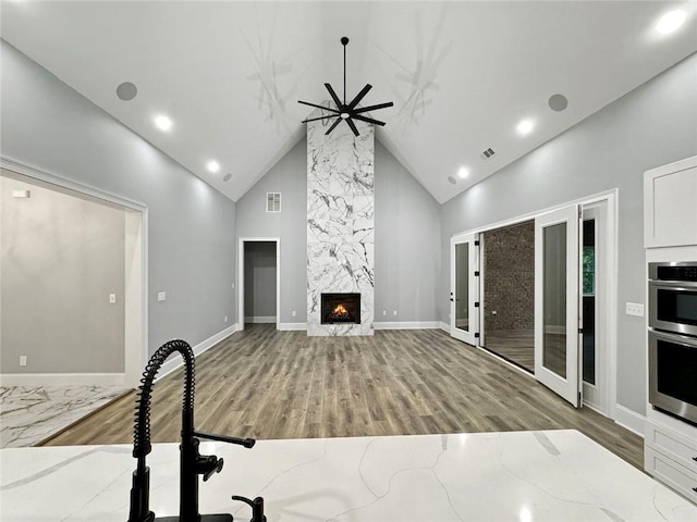 244 Coastline Rd, Fayetteville, GA 30214 - unfurnished living room featuring high vaulted ceiling, wood finished floors, a premium fireplace, ceiling fan, and baseboards