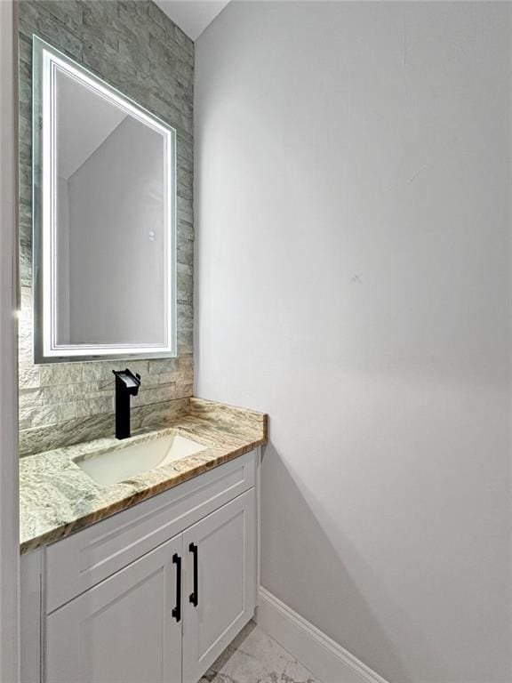 244 Coastline Rd, Fayetteville, GA 30214 - bathroom featuring vanity, marble finish flooring, and baseboards
