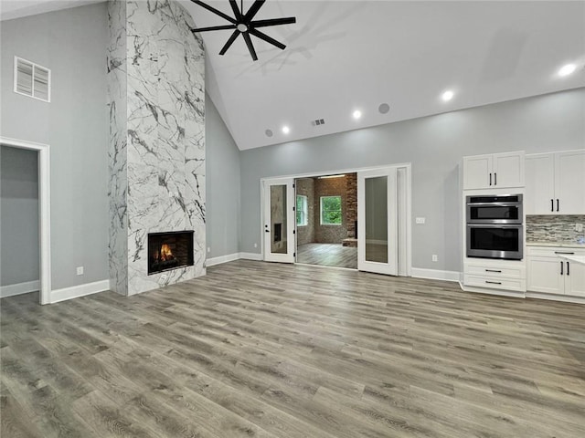 244 Coastline Rd, Fayetteville, GA 30214 - unfurnished living room featuring high vaulted ceiling, recessed lighting, a fireplace, baseboards, and light wood finished floors