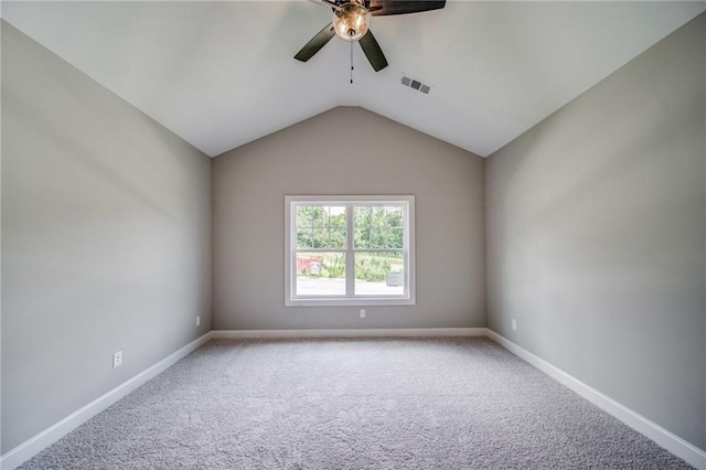 empty room with vaulted ceiling, carpet, and ceiling fan