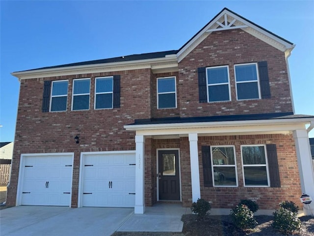 view of front of home with driveway, a garage, and brick siding