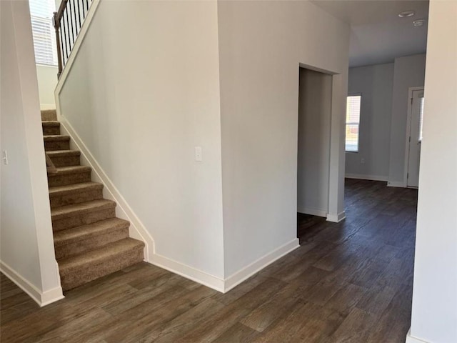 stairway featuring baseboards and wood finished floors