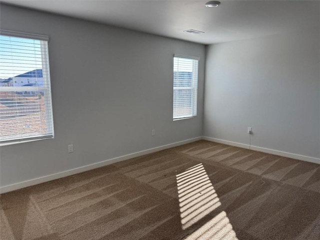 carpeted empty room with baseboards