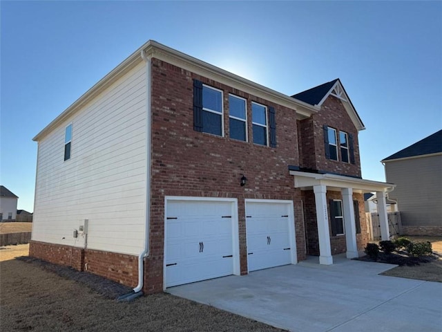 view of front of home featuring a garage, brick siding, and driveway