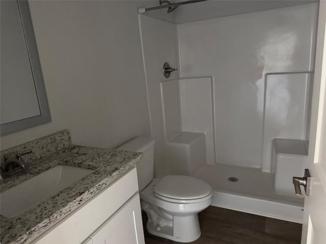 full bath with a shower, vanity, toilet, and wood finished floors