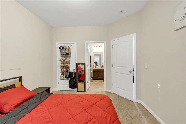 bedroom with light colored carpet and connected bathroom