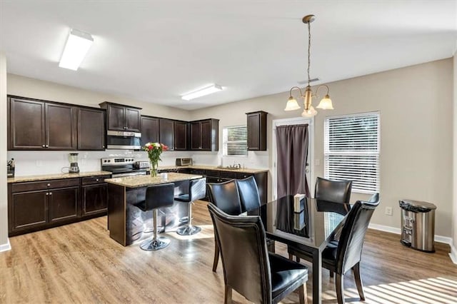 dining space featuring a chandelier and light hardwood / wood-style floors