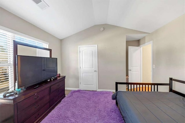 bedroom featuring light colored carpet and lofted ceiling