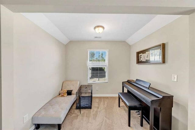 sitting room featuring light carpet and vaulted ceiling