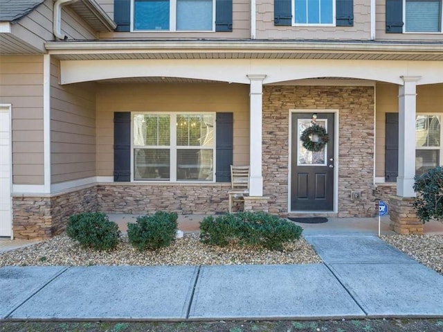 doorway to property featuring covered porch