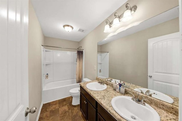 full bathroom with vanity, shower / bath combo, and toilet