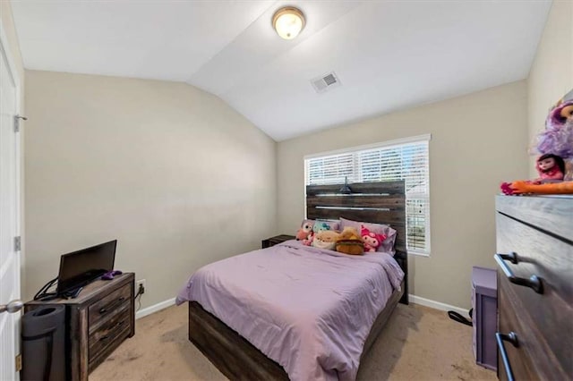 carpeted bedroom with lofted ceiling