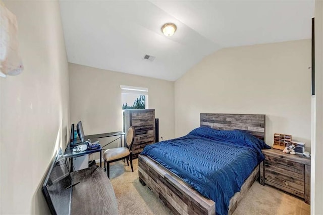 carpeted bedroom with vaulted ceiling