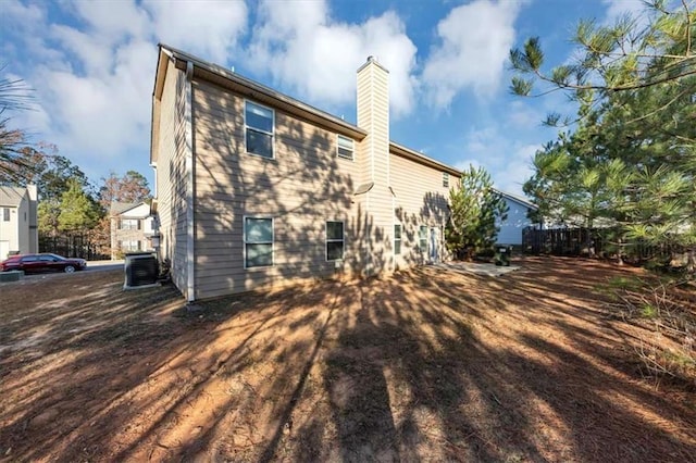 rear view of property with cooling unit