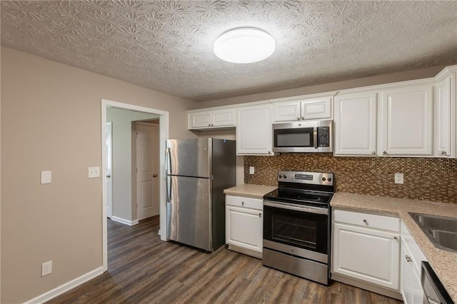 225 Fireside Way, Fairburn, GA 30213 - kitchen featuring stainless steel appliances, dark wood-type flooring, tasteful backsplash, white cabinetry, and light countertops