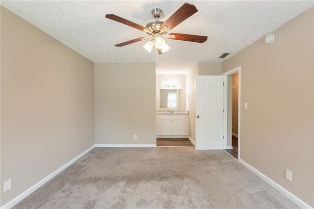 225 Fireside Way, Fairburn, GA 30213 - unfurnished bedroom with carpet floors, a textured ceiling, baseboards, ensuite bathroom, and ceiling fan