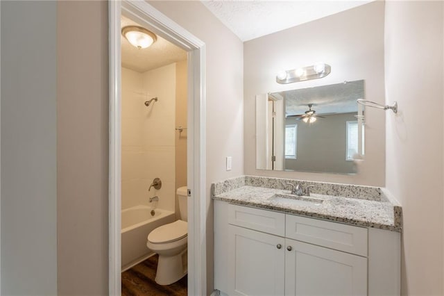 225 Fireside Way, Fairburn, GA 30213 - full bath featuring toilet, vanity, wood finished floors, shower / bath combination, and a textured ceiling