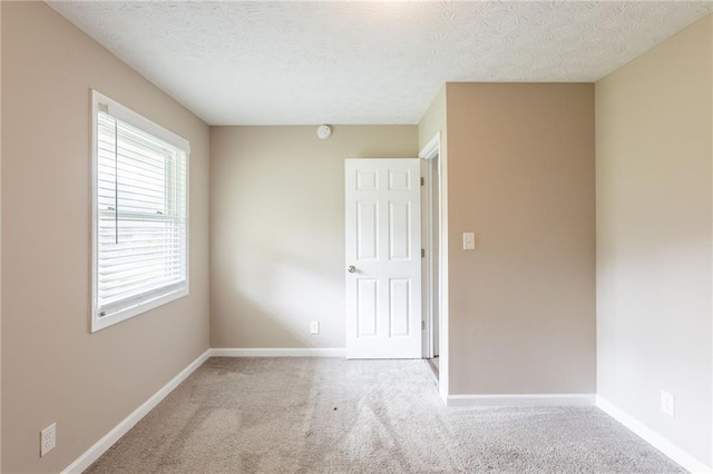 225 Fireside Way, Fairburn, GA 30213 - empty room with carpet floors, baseboards, a textured ceiling, and a smoke detector