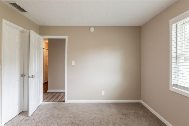 225 Fireside Way, Fairburn, GA 30213 - unfurnished bedroom featuring light carpet and baseboards