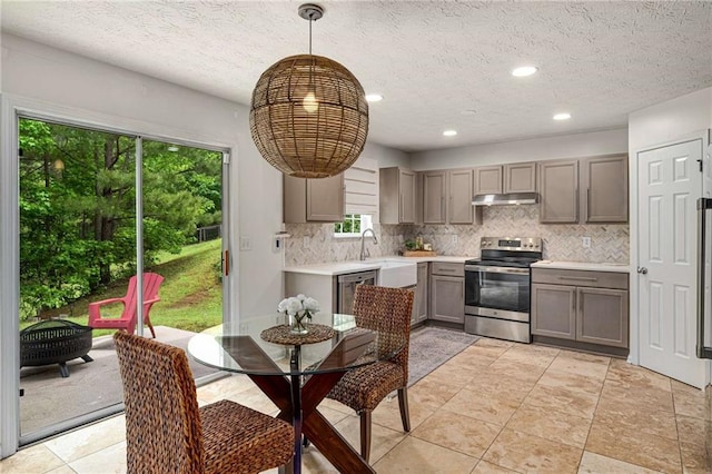 kitchen with gray cabinetry, backsplash, electric range, and a sink