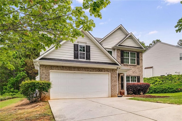 view of front of house with brick siding, a garage, and driveway
