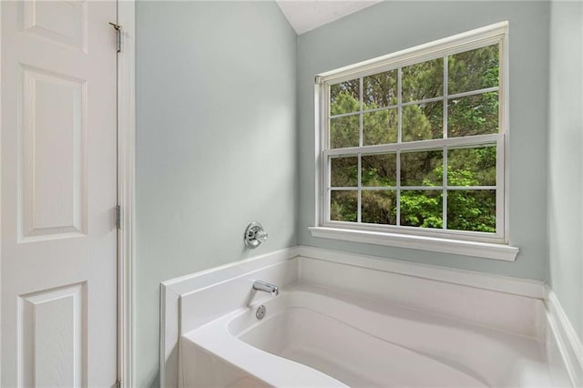 full bathroom with a bath and a wealth of natural light