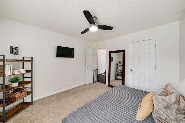 bedroom featuring baseboards, ceiling fan, and light carpet