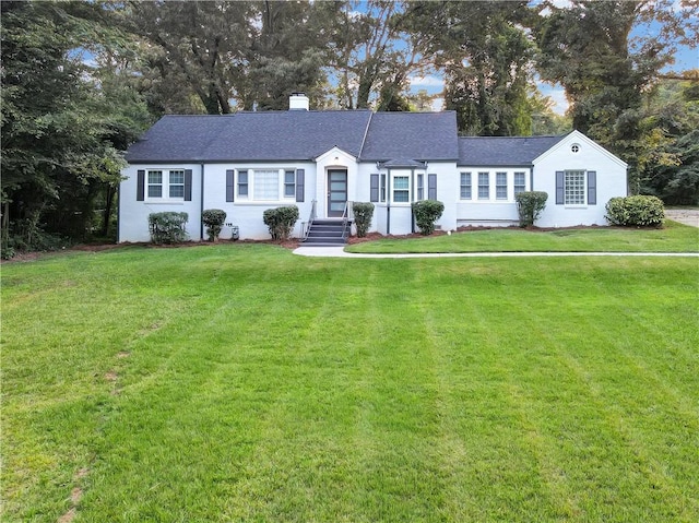 ranch-style home featuring a front yard