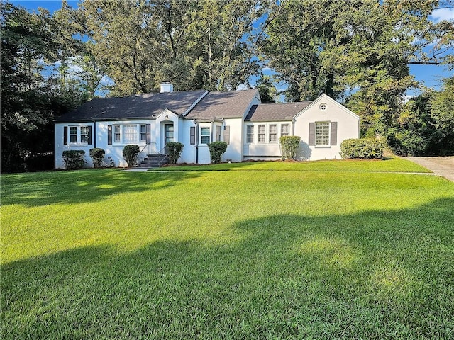 ranch-style house with a front lawn