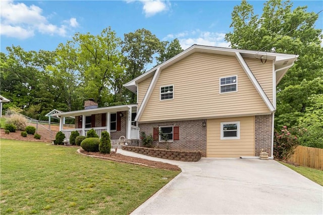 3781 Cherokee Trl, Suwanee, GA 30024 - split level home featuring a porch, driveway, brick siding, and fence
