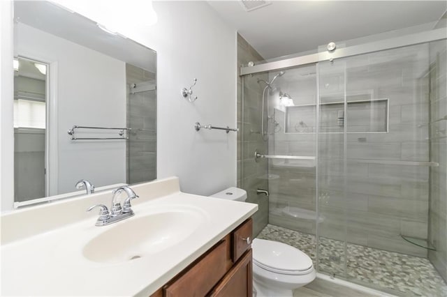 3781 Cherokee Trl, Suwanee, GA 30024 - full bathroom featuring vanity, toilet, a shower stall, and visible vents