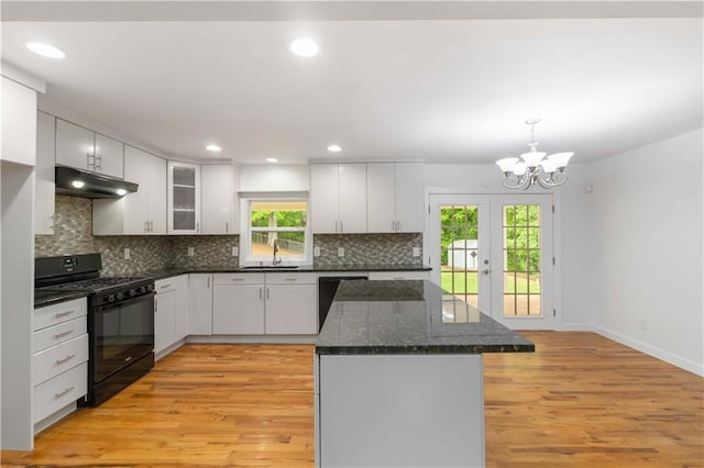 3781 Cherokee Trl, Suwanee, GA 30024 - kitchen with light wood-style flooring, a sink, under cabinet range hood, dishwasher, and gas stove