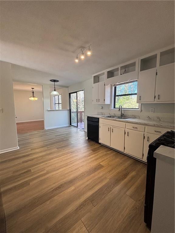 kitchen with pendant lighting, sink, dishwasher, range with gas stovetop, and white cabinets