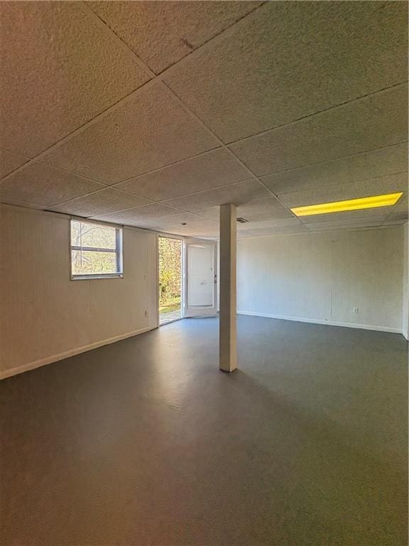 basement with a paneled ceiling