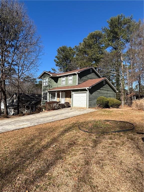 view of front of house featuring a garage, a front lawn, and a porch