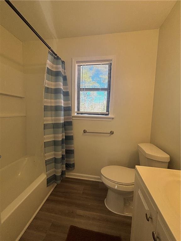 full bathroom featuring hardwood / wood-style flooring, vanity, toilet, and shower / bath combo with shower curtain