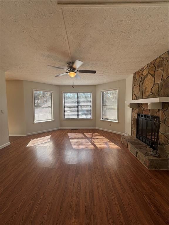 unfurnished living room with hardwood / wood-style floors, a textured ceiling, a fireplace, and ceiling fan