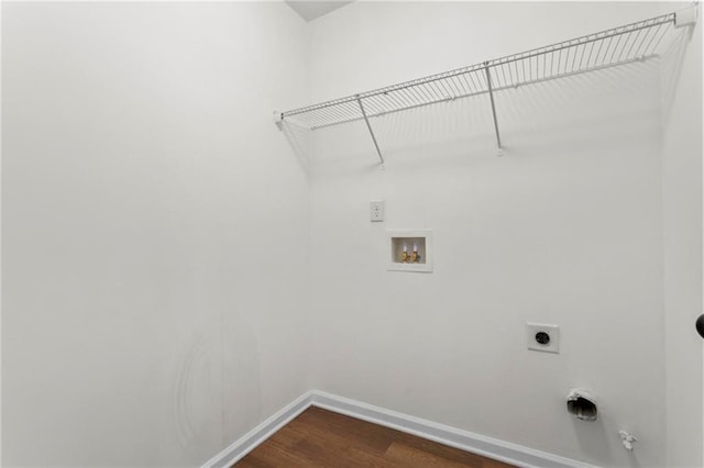 washroom with laundry area, dark wood finished floors, hookup for an electric dryer, washer hookup, and baseboards